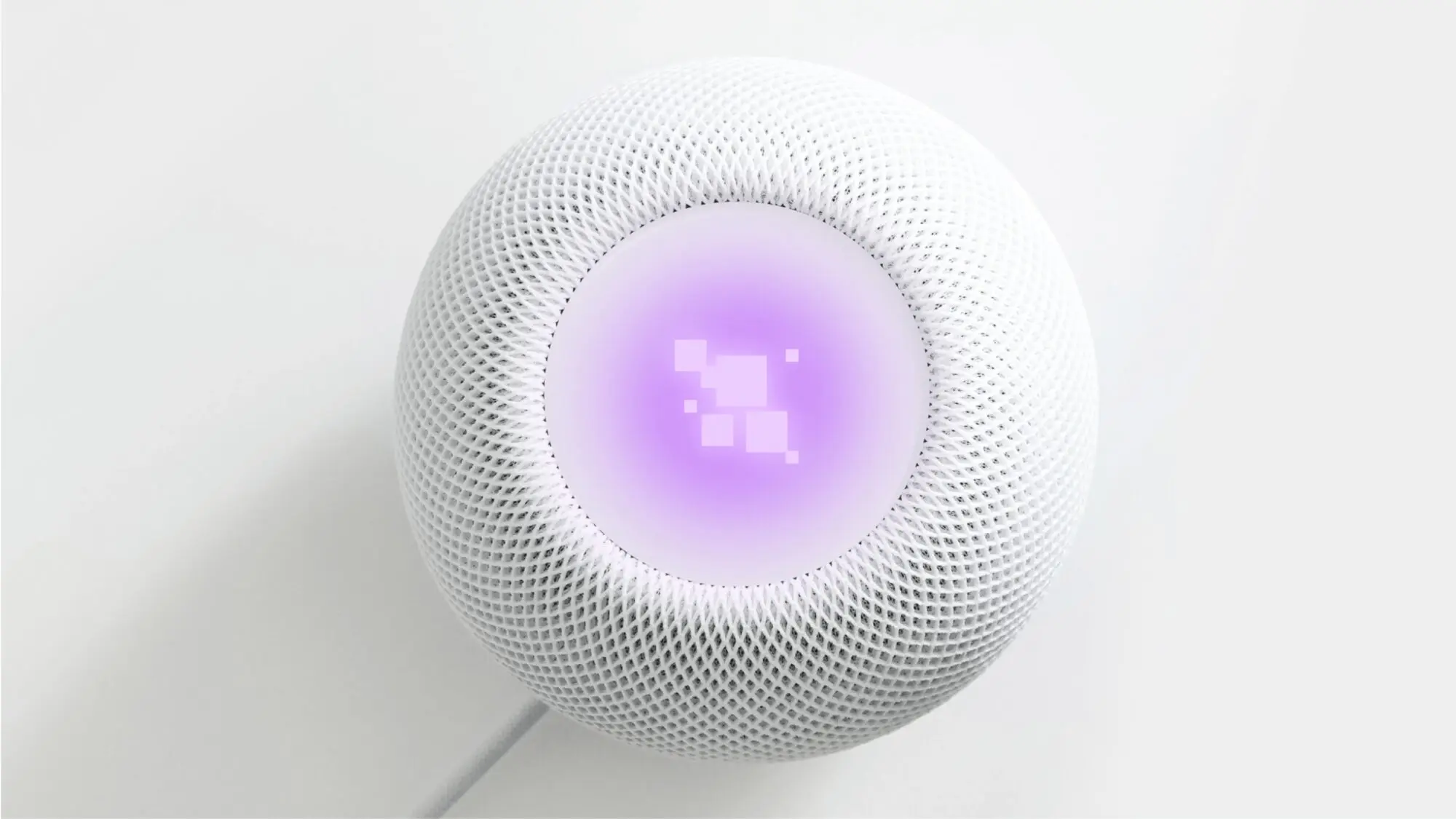 Top down view of a smart speaker showing a purple animation of the BBC voice assistant.