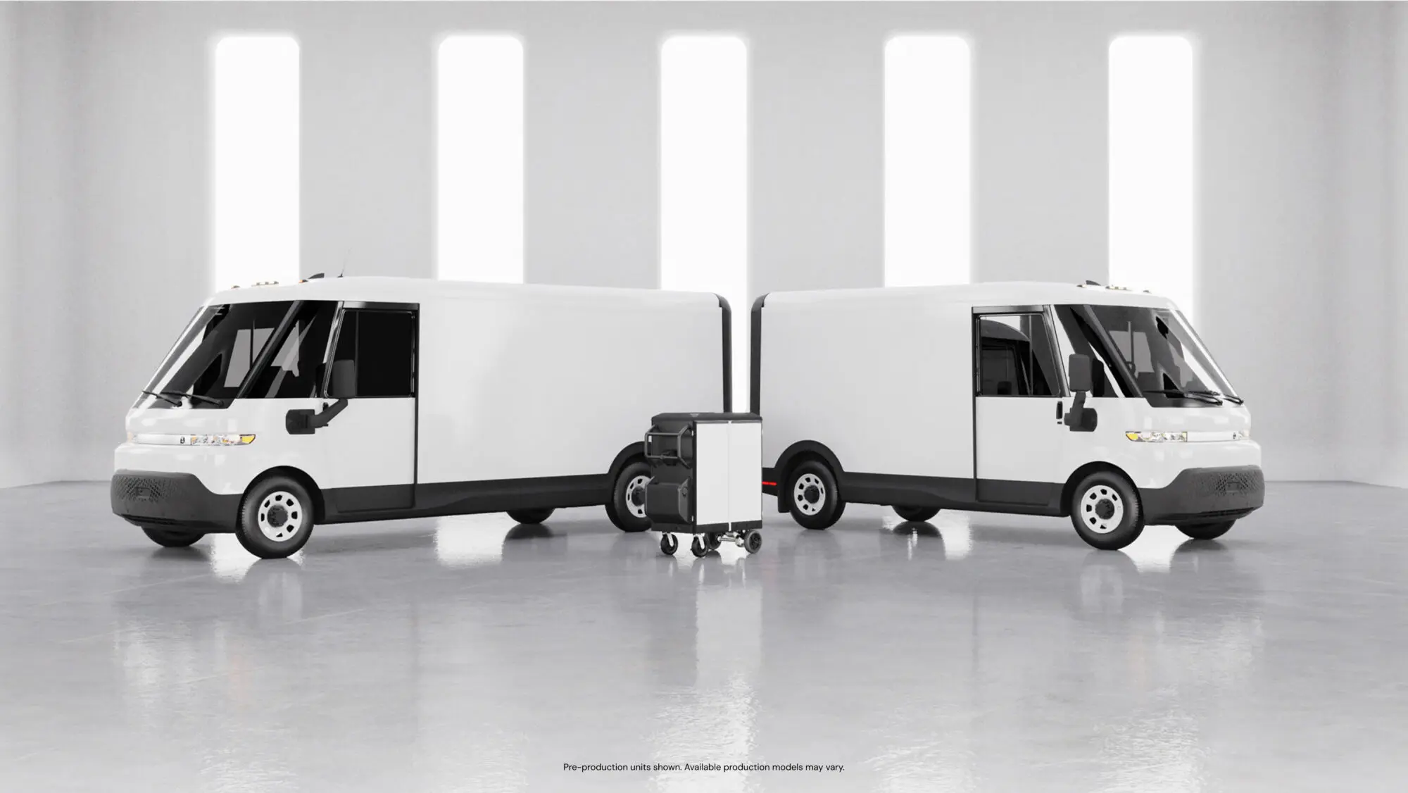 Two electric delivery vans with their backs to one another.