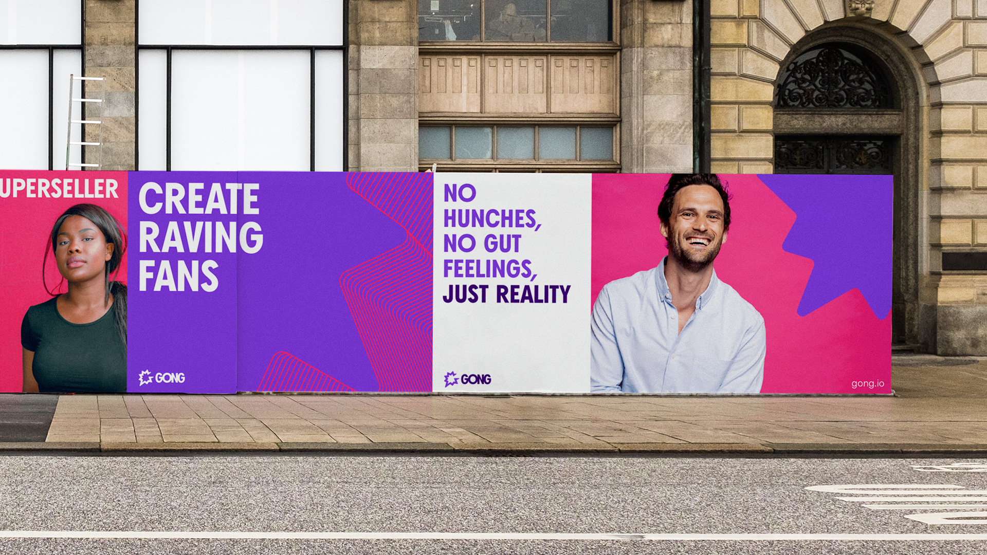 A street with multiple graphic Gong posters pasted on the wall. The poster on the right features a man smiling and next to it the title “No hunches, no gut feelings, just reality”.